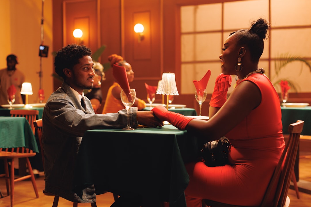 A Modern High End Photorealistic Image Of A Young Couple Sitting At A Stylish Dining Table With A